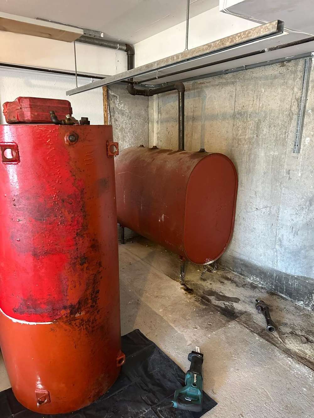 Old oil tank being removed from a Long Island basement